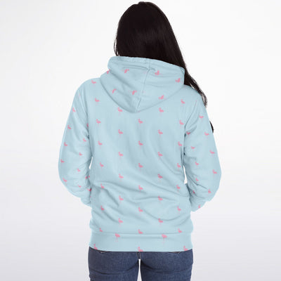 Light blue hoodie with pink flamingo pattern worn by a person on a white background
