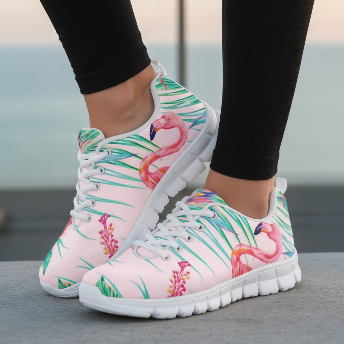 Colorful sneakers with flamingo and palm leaf design worn by a person.