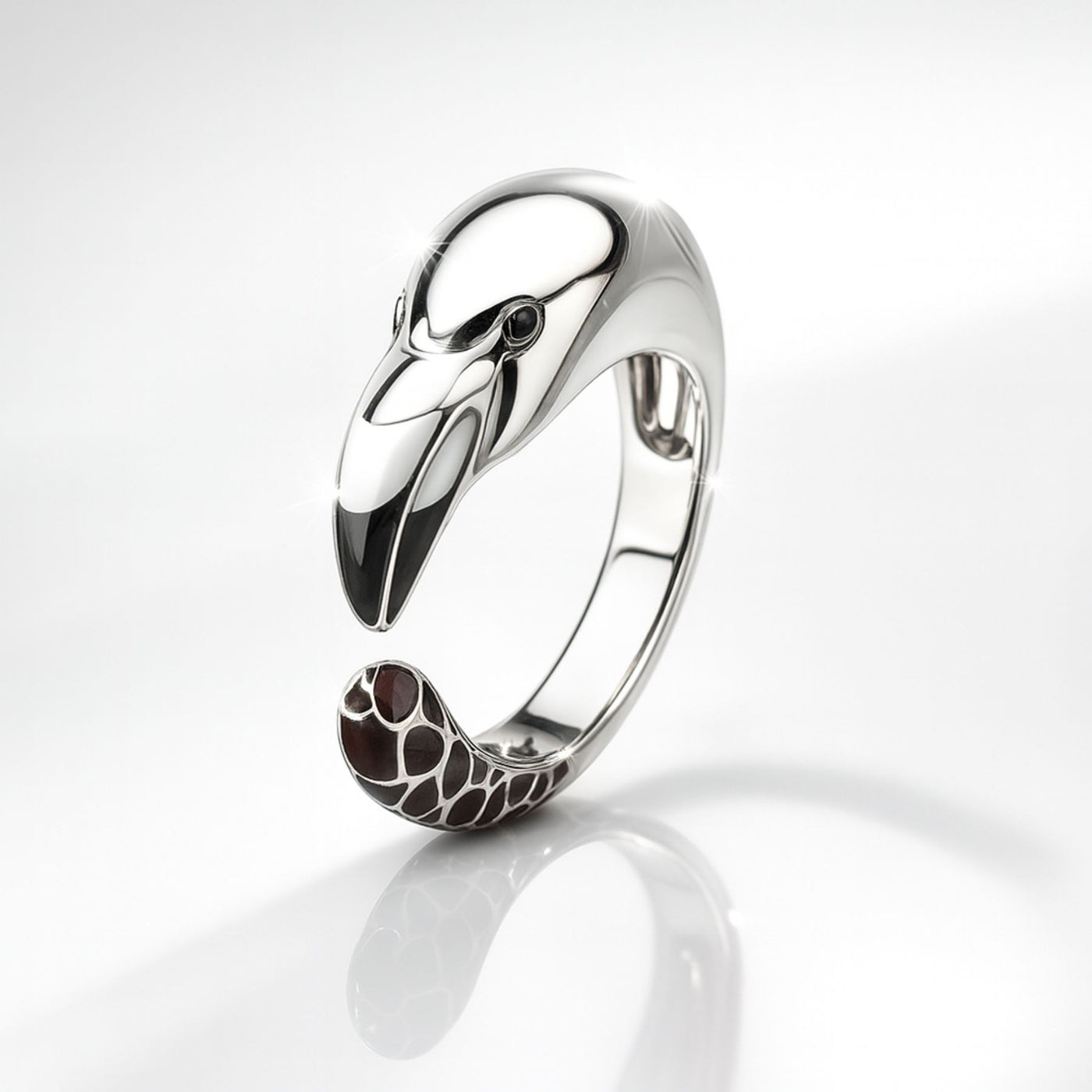 Silver flamingo-shaped ring with a detailed design on a white background