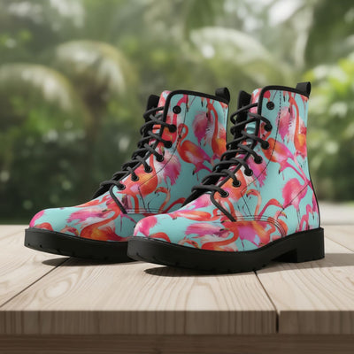 Colorful floral-patterned boots on a wooden surface with a blurred green background