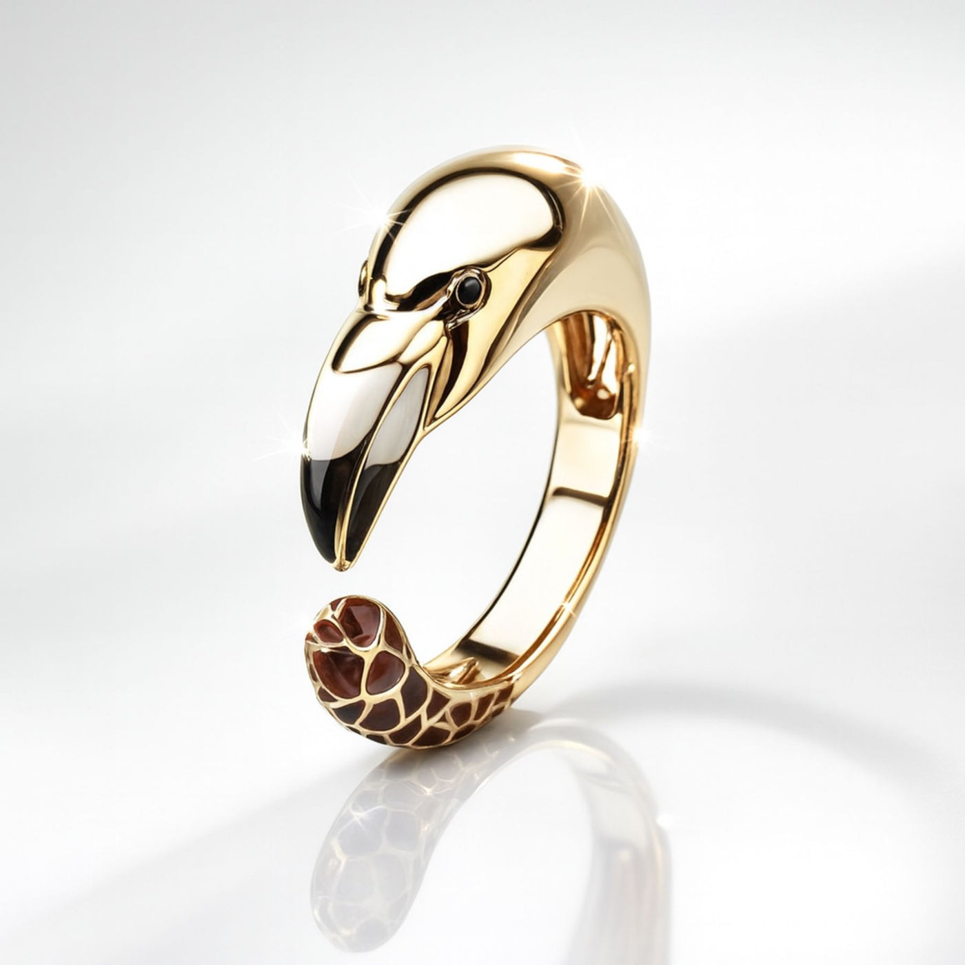 Gold flamingo-shaped ring with a detailed design on a white background