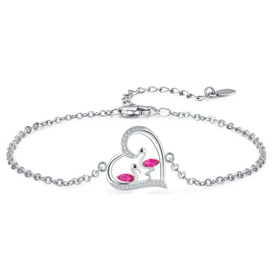 Silver flamingo bracelet with a heart-shaped clasp featuring red gemstones on a white background