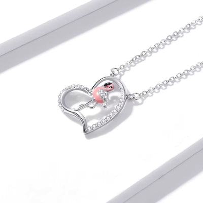 Heart-shaped necklace with a pink pendant on a white background