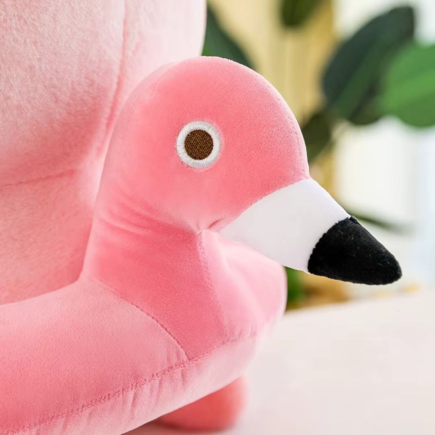Close-up of a pink flamingo plush toy with a blurred background