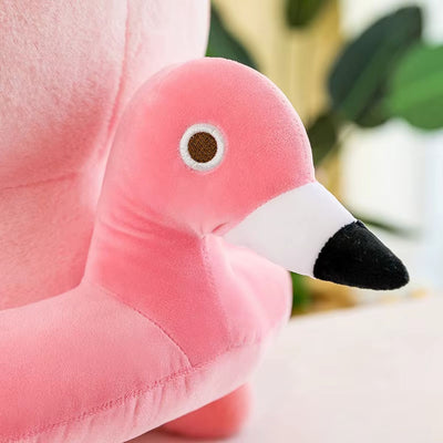 Close-up of a pink flamingo plush toy with a blurred background