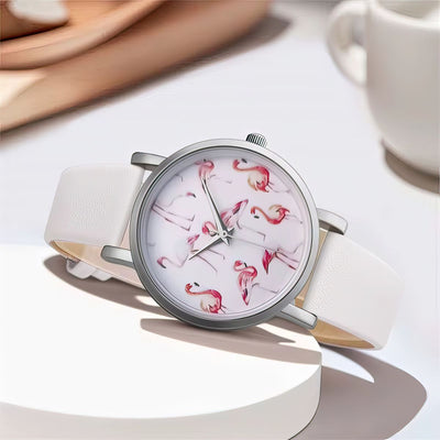 Watch with flamingo design on a white surface