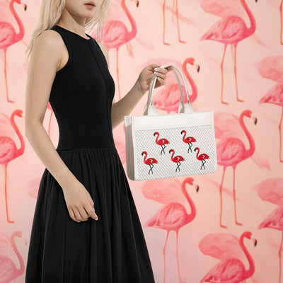 Woman holding a white handbag with flamingo design against a pink flamingo patterned background