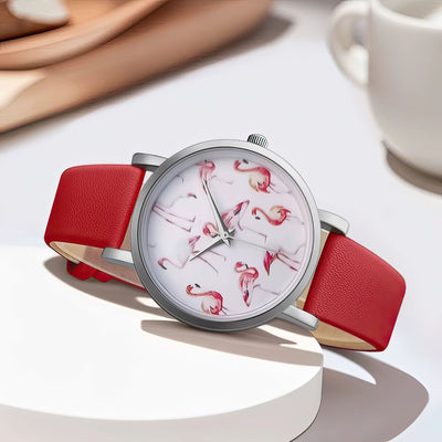 Wristwatch with red strap and flamingo pattern on a white surface