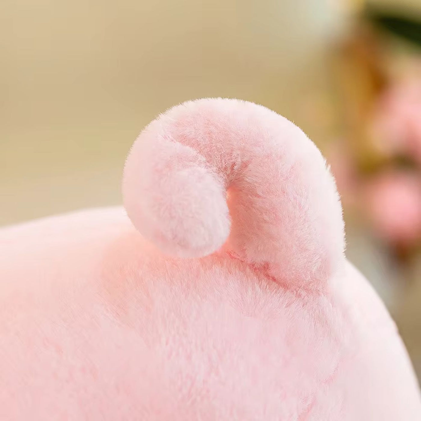 Close-up of a pink plush toy with a blurred background