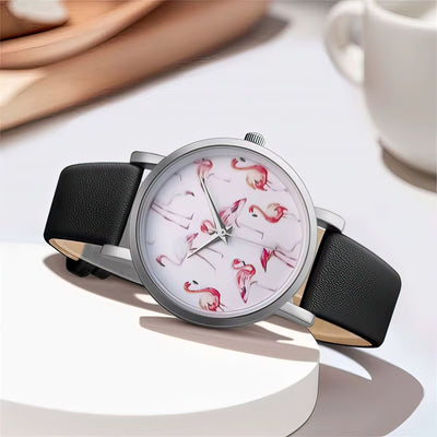 Watch with flamingo design on a white surface