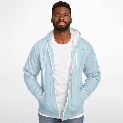 Man wearing a light blue hoodie with pink patterns on a white background
