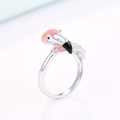 Silver ring with flamingo design on a white background