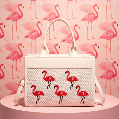 White handbag with flamingo patterns on a pink background