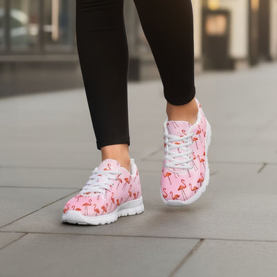 Pink sneakers with flamingo pattern worn on a blurred urban background