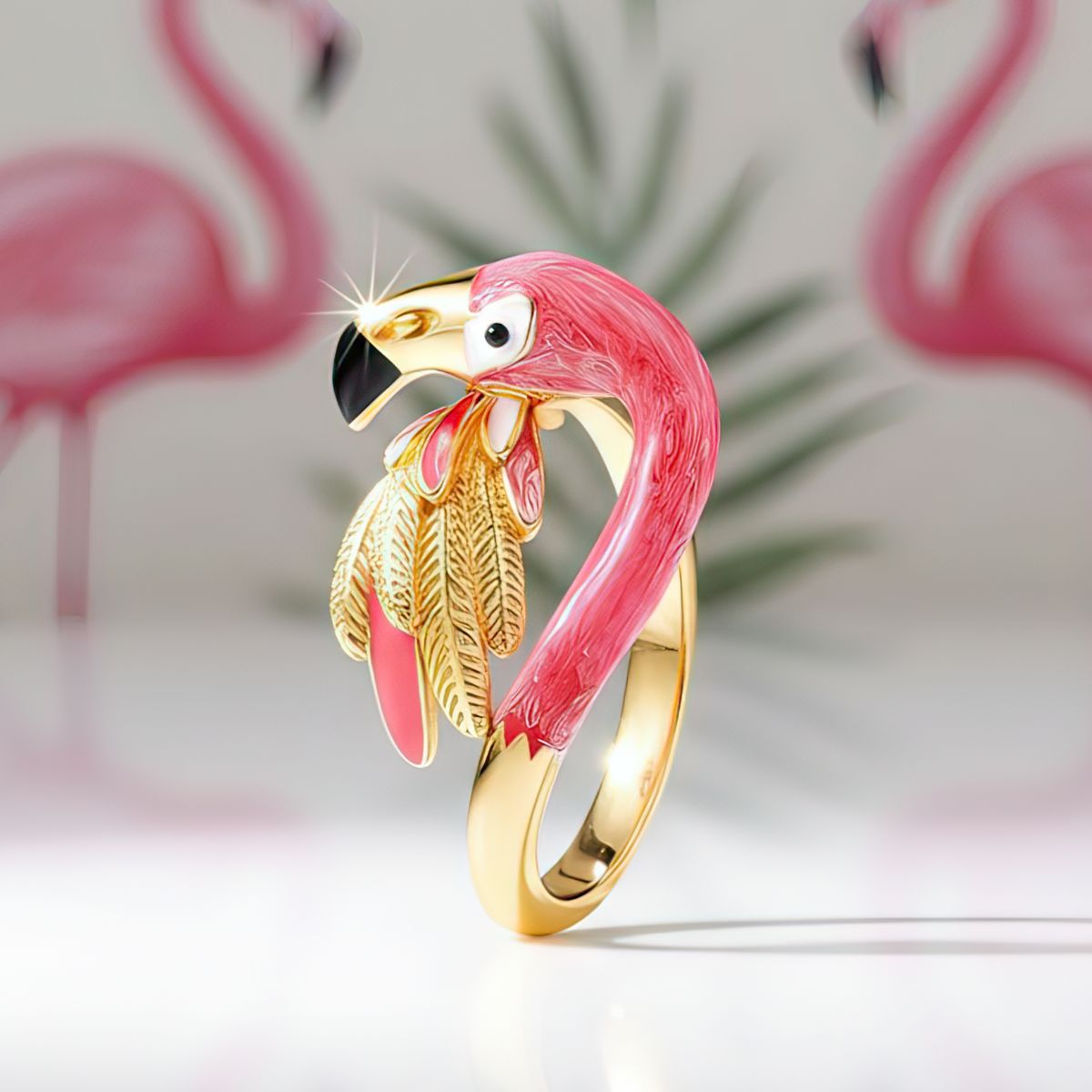 Flamingo-shaped ring with gold and pink design on a light background