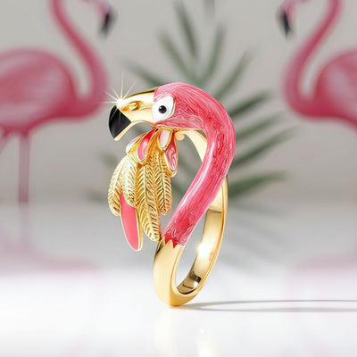 Flamingo-shaped ring with gold and pink design on a light background
