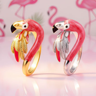 Two flamingo-shaped rings, one gold and one silver, on a pink background with flamingo illustrations.