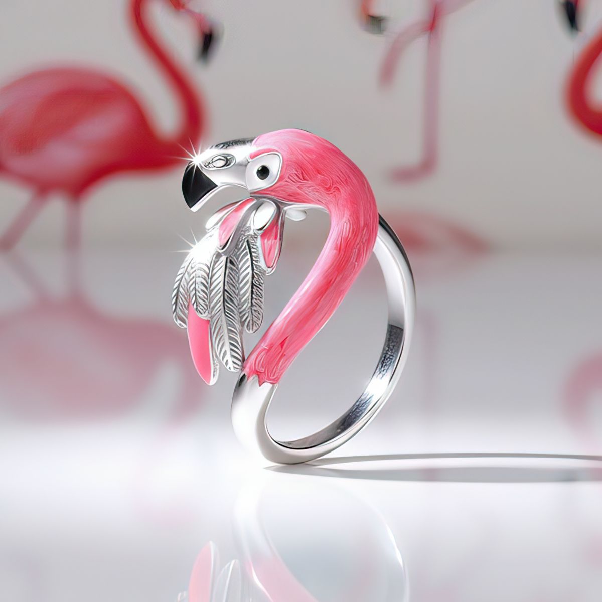 Flamingo-shaped ring with pink and silver design on a white background