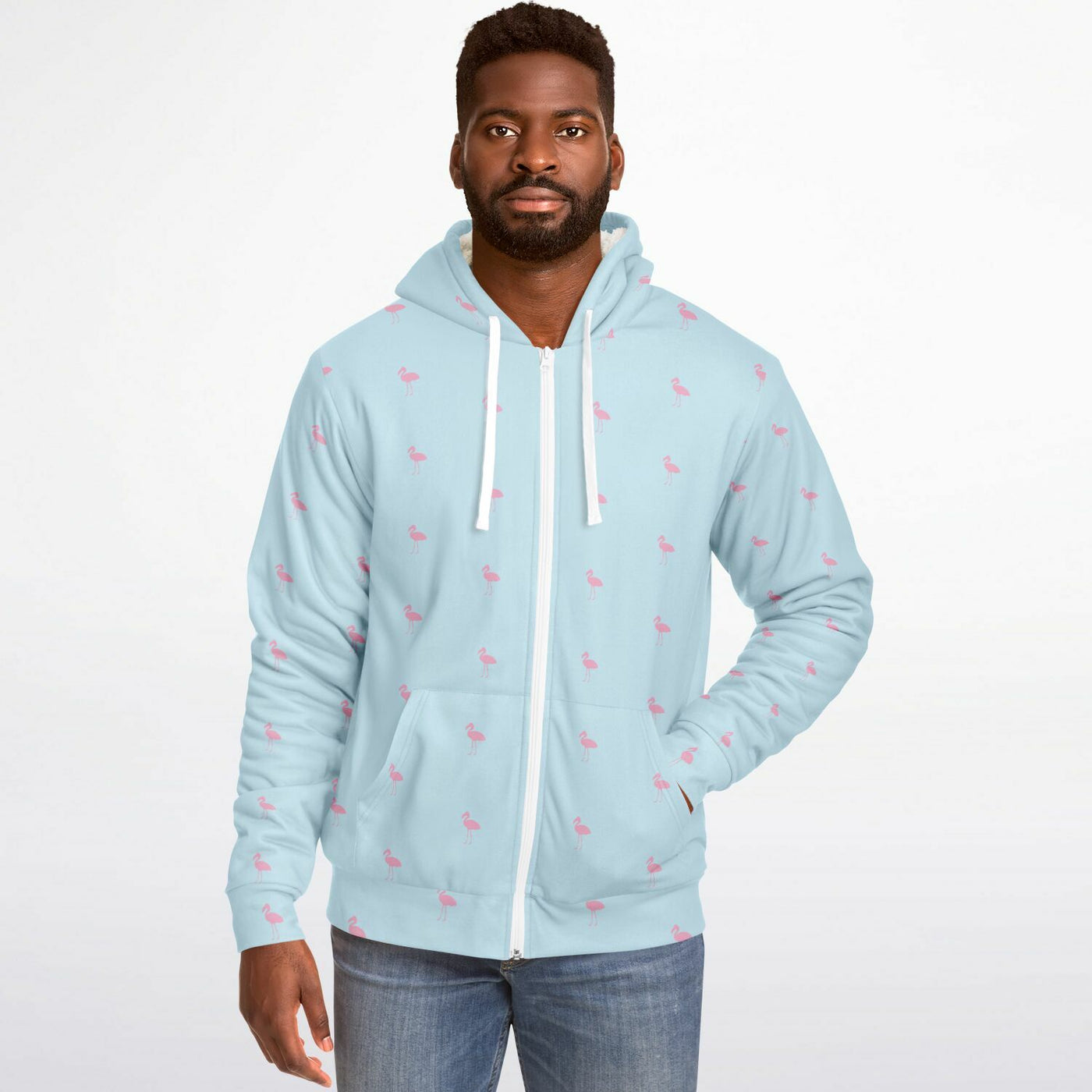 Man wearing a light blue hoodie with small patterns on a white background